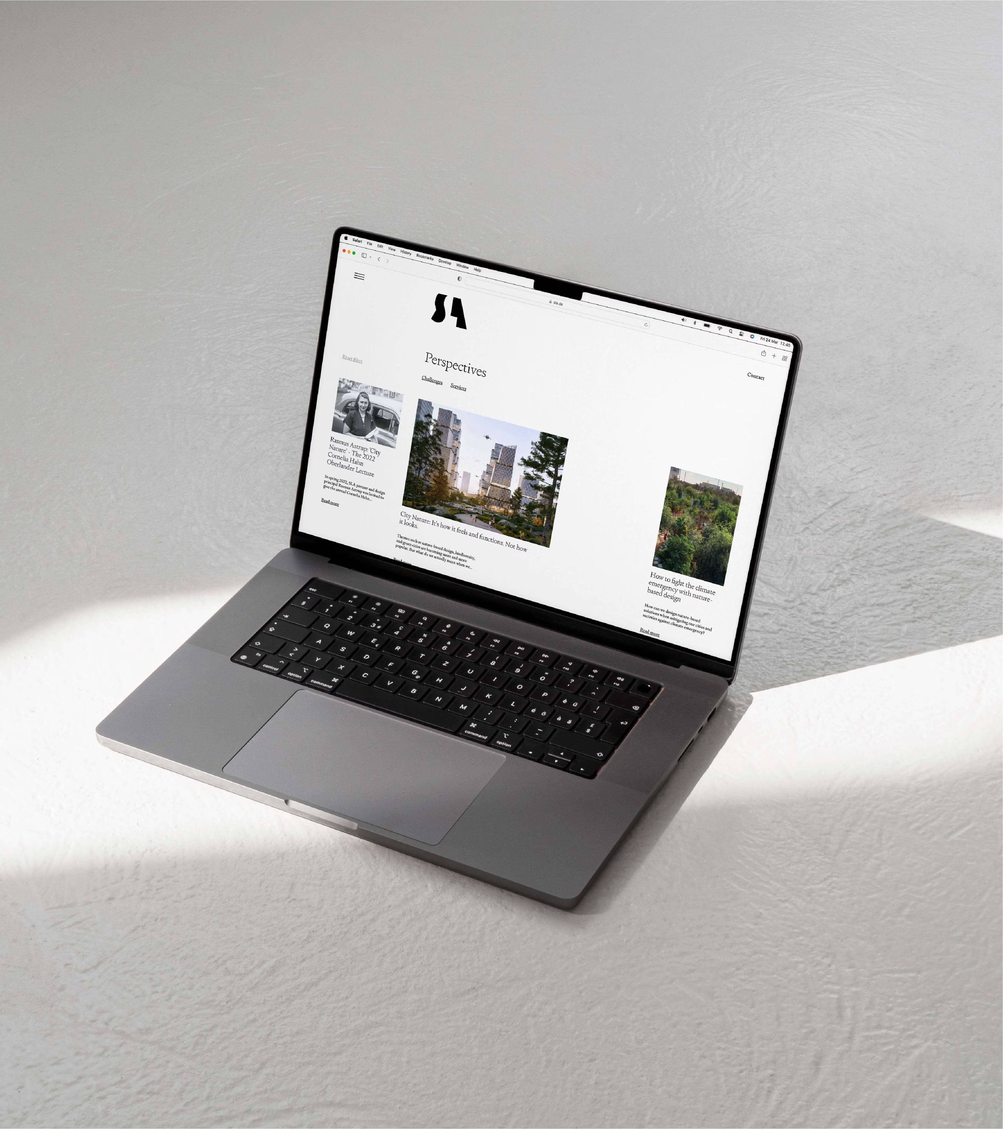 The SLA landscape architects website open on a laptop in soft daylight